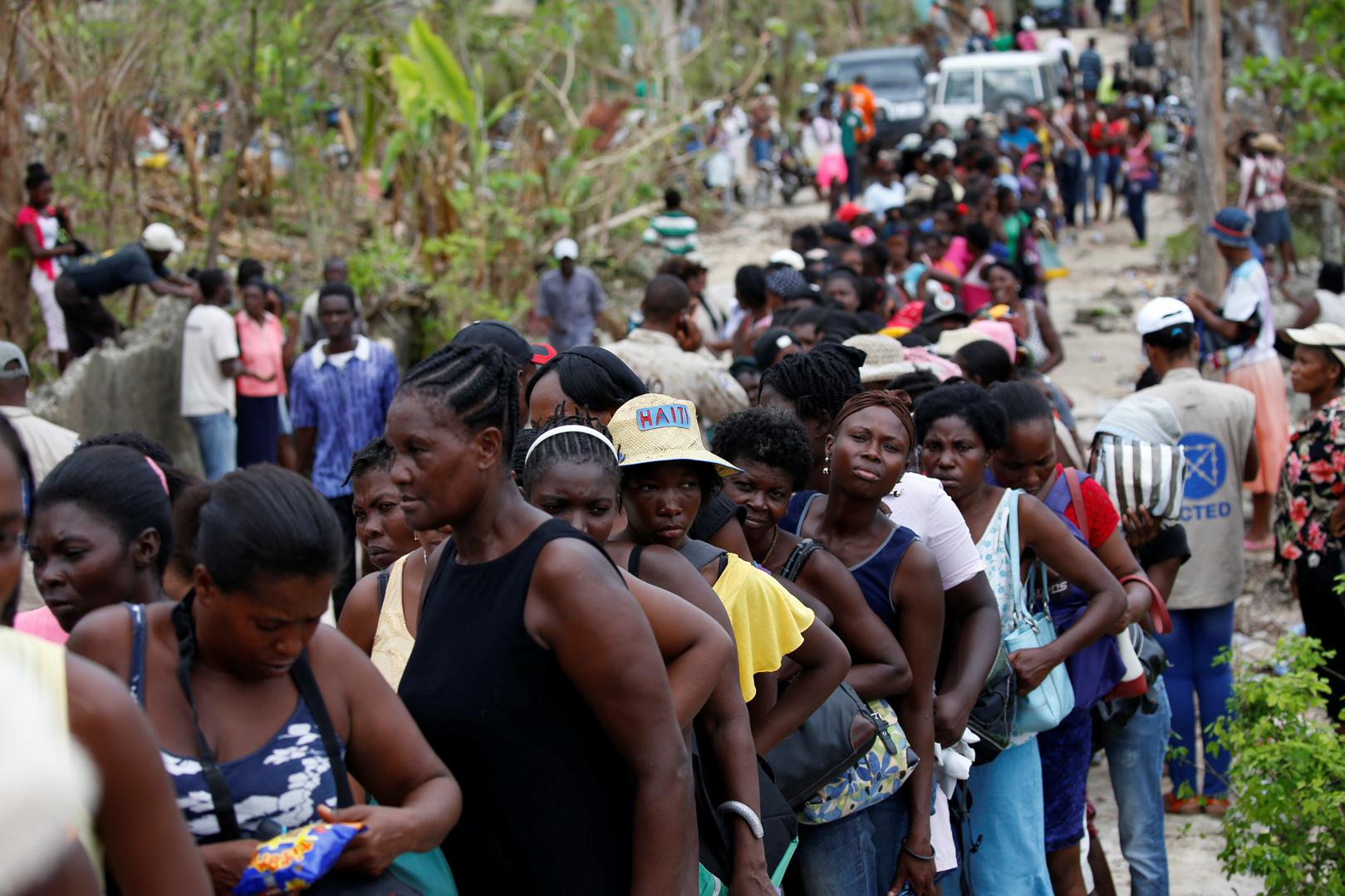 People make a line as they wait for food to be handed out after Hurricane Matthew hit Jeremie, Haiti, October 19, 2016. 
