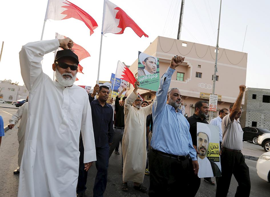Protesters hold photos of Sheikh Ali Salman, Bahrain's main opposition leader and Secretary-General of Al-Wefaq Islamic Society, as they march demanding his release in the village of Jidhafs, west of Manama, Bahrain, June 16, 2015.