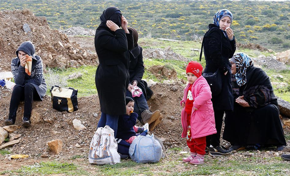 Une famille de réfugiés syriens photographiée au bord d’une route près de la ville côtière de Didim, siutee dans l’ouest de la Turquie face à la mer Égée, le 9 mars 2016.