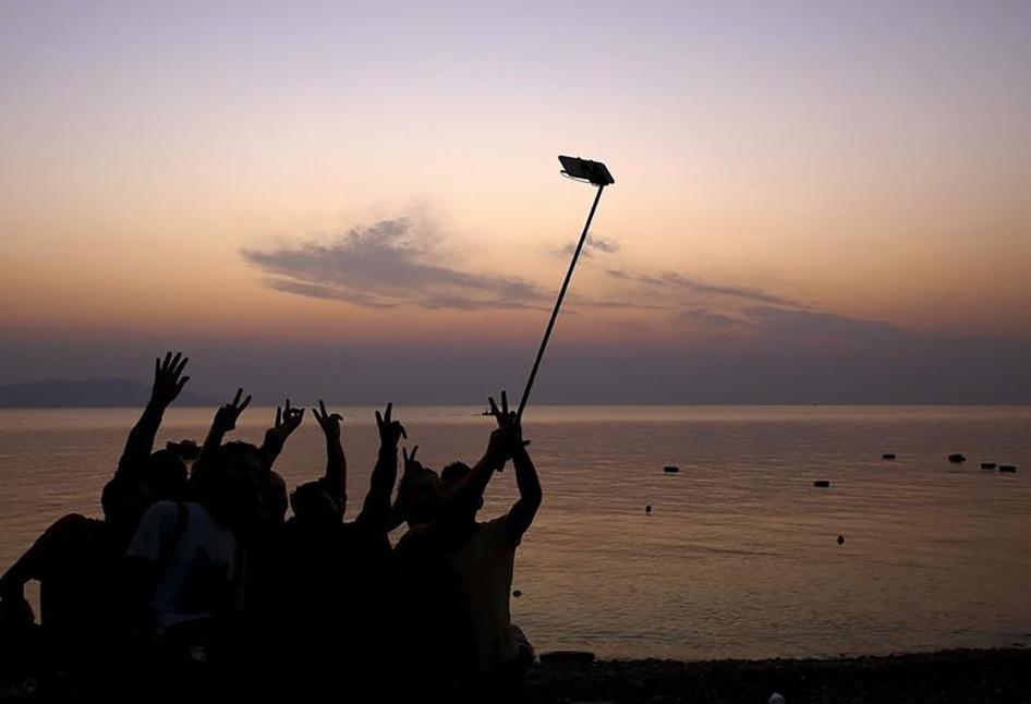 Syrian refugees take "selfies" moments after arriving on an overcrowded dinghy at a beach on the Greek island of Kos.