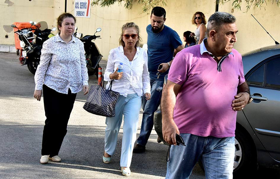Turkish journalist Nazli Ilicak, a well-known commentator and former parliamentarian, is escorted by a police officer and her relatives after being detained in Bodrum, Turkey on July 26, 2016.