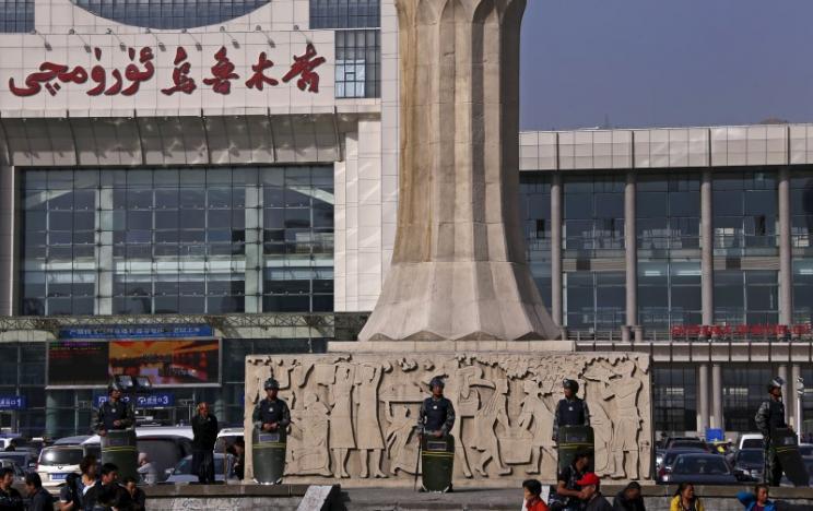 Police stand outside the South Railway Station in Urumqi, Xinjiang Uighur Autonomous Region on May 2, 2014.