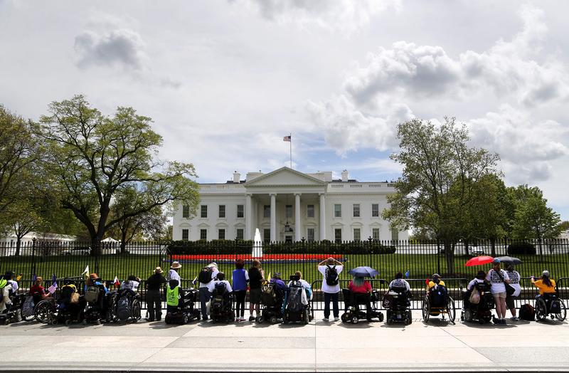 Protesters with ADAPT, a disabled people's rights organization, stage a demonstration at the gates of the White House in Washington, April 20, 2015.
