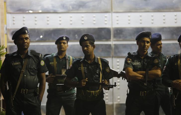 Police officers stand guard in front of the central jail in Dhaka on December 12, 2013.