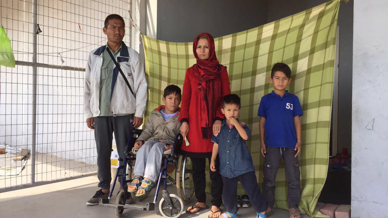 Eight-year-old Ali, with multiple disabilities, in front of his makeshift shelter at Elliniko camp in Athens where he lived with his parents and siblings and more than 3,000 other asylum seekers and migrants in October 2016. Photograph by Emina Cerimovic