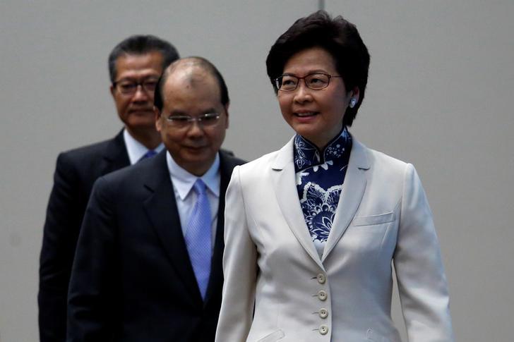 Hong Kong Chief Executive-elect Carrie Lam (R) enters a news conference with Chief Secretary Matthew Cheung (C) and Financial Secretary Paul Chan in Hong Kong, China June 21, 2017. REUTERS/Bobby Yip
