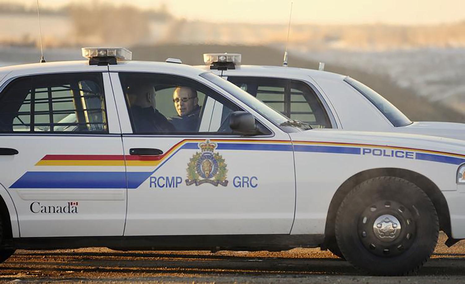 Two Royal Canadian Mounted Police (RCMP) officers talk at a blockade on a country road in the province of Alberta. © 2012 Reuters