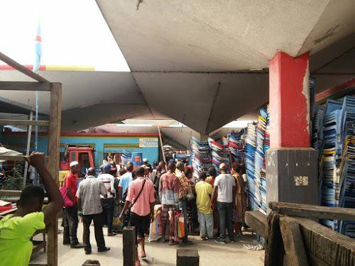 People gather outside the office of the administrator of Kinshasa’s central market, Democratic Republic of Congo, on July 15, 2017, one day after she was killed.