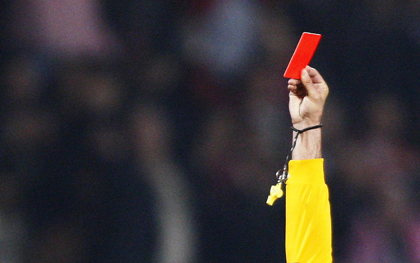 A red card raised at a soccer match, symbolizing Red Card Kenya, an organization comprised of four Kenyan civil society groups, which named 20 candidates unfit to run for elections in a recent report