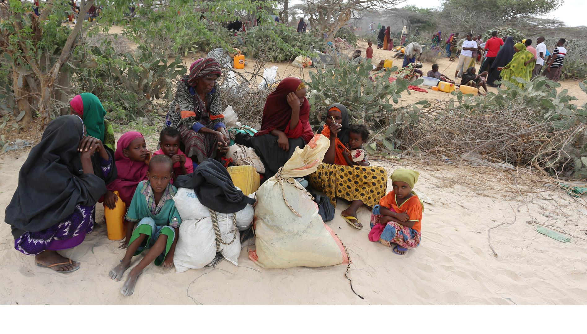 Somali families rest as they flee from drought-stricken Lower Shabelle region before entering makeshift camps in Somalia's capital, Mogadishu, joining the thousands already displaced, March 17, 2017. Al-Shabab forces attacked villages in Lower Shabelle re
