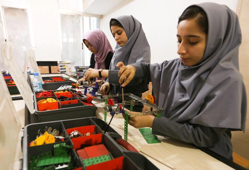 Members of Afghan robotics girls team which was denied entry into the United States for a competition, work on their robots in Herat province, Afghanistan July 4, 2017.