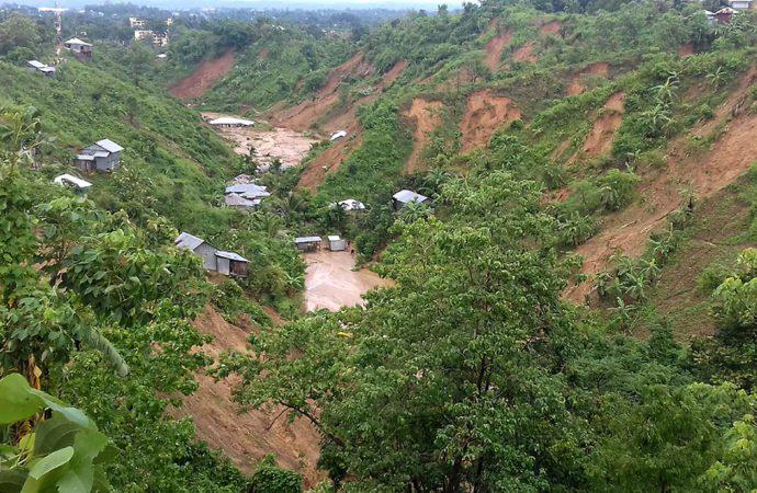 This general view shows dwellings under mud after a landslide in Rangamati on June 13, 2017. 