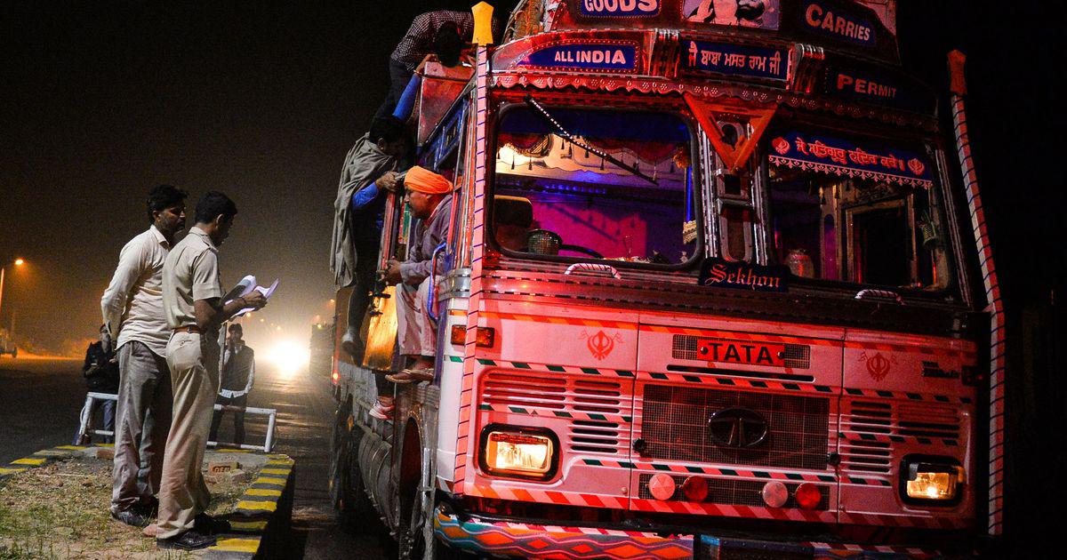 Volunteers with a cow protection squad inspect a truck on a highway in Taranagar, Rajasthan, on November 5, 2015. 