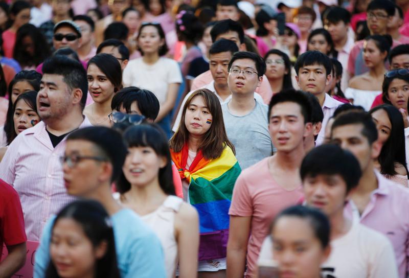 A woman wrapped in the rainbow flag is seen at the Pink Dot rally, Singapore's annual gay pride rally, at a park in Singapore July 1, 2017.
