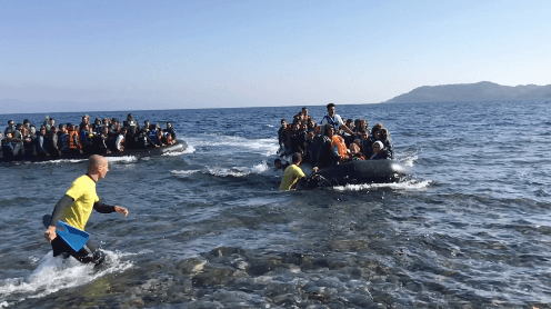 Rubber boats full of asylum seekers and other migrants arriving on the shore of Lesbos Island, Greece.