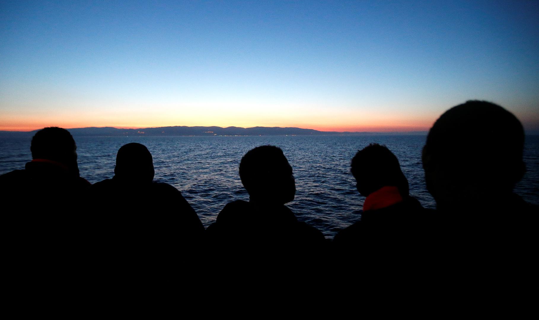 Migrants look at south Italy's coast as they approach on the Vos Hestia ship after being rescued by " Save the Children" crew on the Mediterranean sea off the Libya coast, June 20, 2017. 
