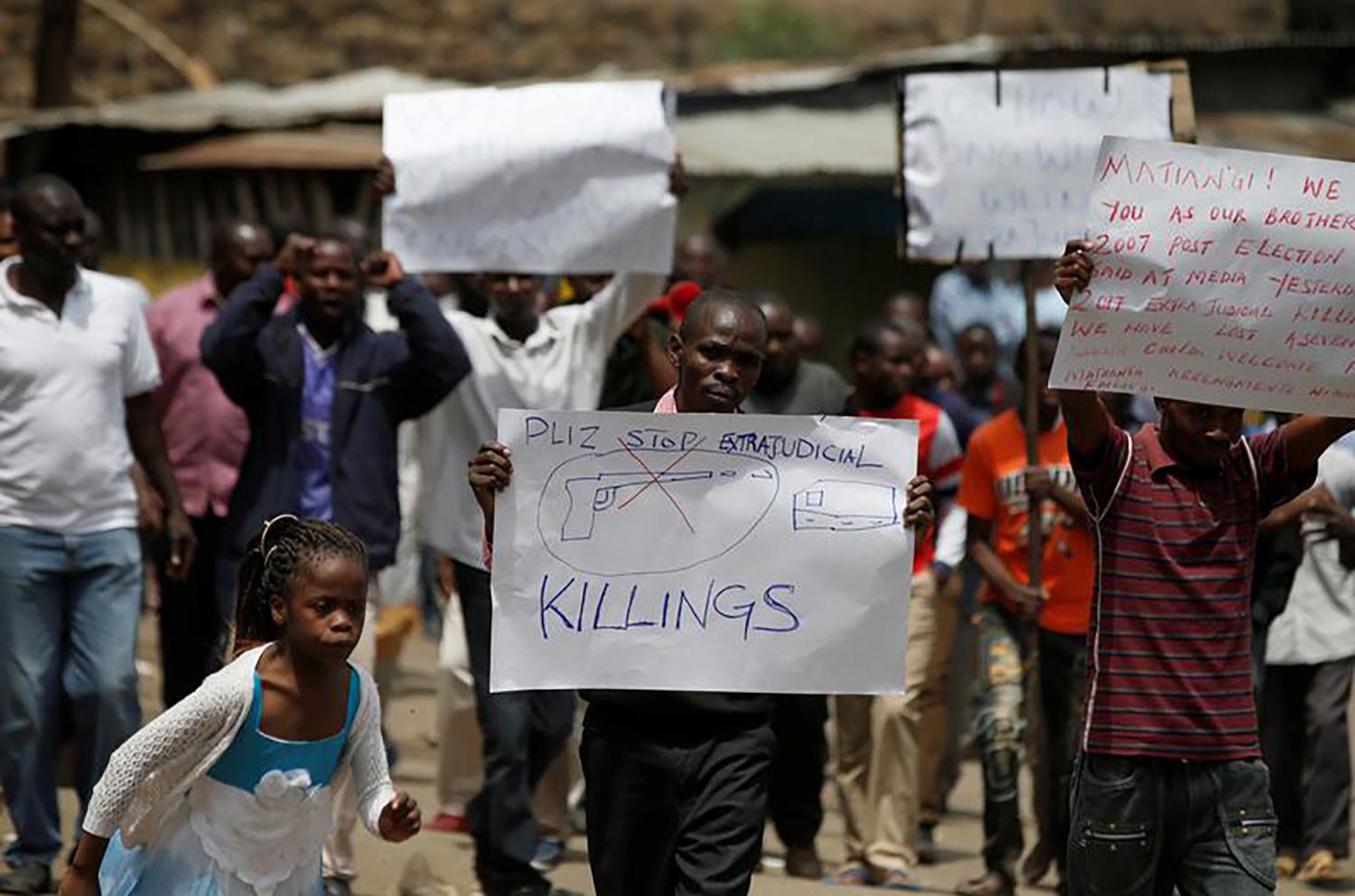 Protesters hold a sign in the Mathare slum in Nairobi, Kenya, August 13, 2017. 