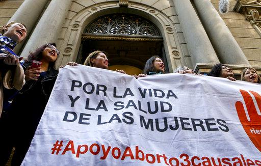 Pro-abortion activist take part in a demonstration in front of the Constitutional Court where opposing parliamentarians presented arguments against the newly approved law that allows abortions under limited circumstances, in Santiago, Chile.