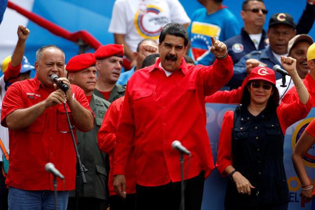 Venezuela's President Nicolas Maduro (C), his wife Cilia Flores and Diosdado Cabello, deputy of Venezuela's United Socialist Party, attend the closing campaign ceremony for the upcoming Constituent Assembly election in Caracas, Venezuela July 27, 2017.