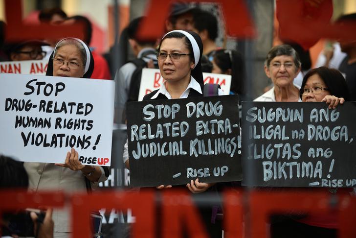 Catholic nuns hold placards as they protest against drug-related extrajudicial killings, on International Human Rights Day in Manila, Philippines, December 10, 2016.