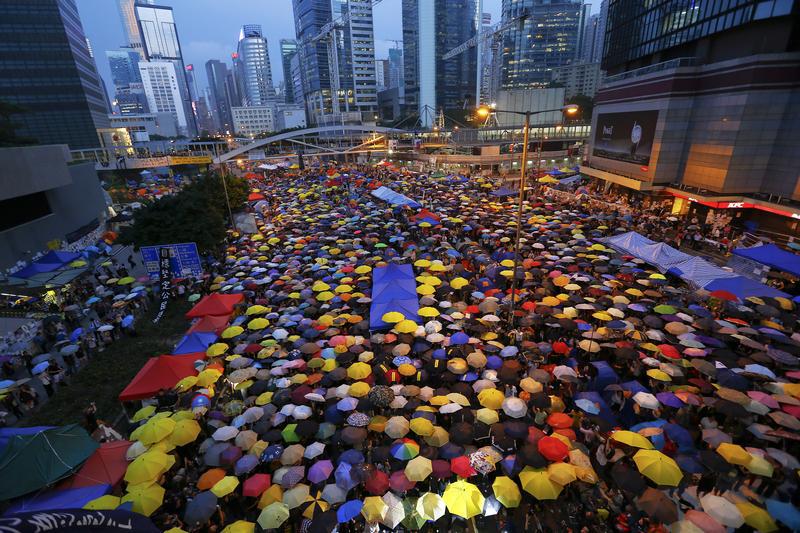 Protesters open their umbrellas, symbols of pro-democracy movement, as they mark exactly one month since they took the streets in Hong Kong's financial central district October 28, 2014.