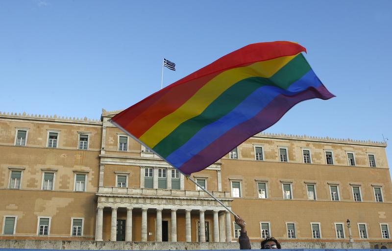 A protestor waves a rainbow flag during a gay protest outside the Greek parliament in Athens September 29, 2008.