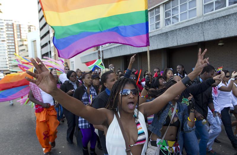 A woman holds her hands up during the Durban Pride parade where several hundred people marched through the Durban city centre in support of gay rights, July 30, 2011.