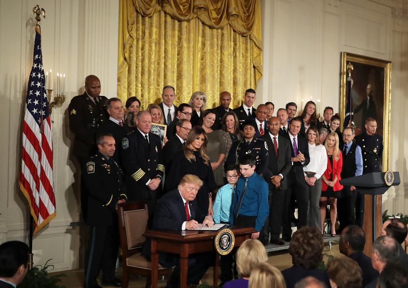 US President Donald Trump signs a presidential public health emergency declaration on the nation's opioid crisis in the East Room of the White House in Washington, DC.