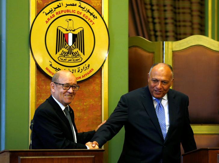 French Foreign Minister Jean-Yves Le Drian shakes hand with Egyptian Foreign Minister Sameh Shoukry after their joint news conference in Cairo, Egypt June 8, 2017. 