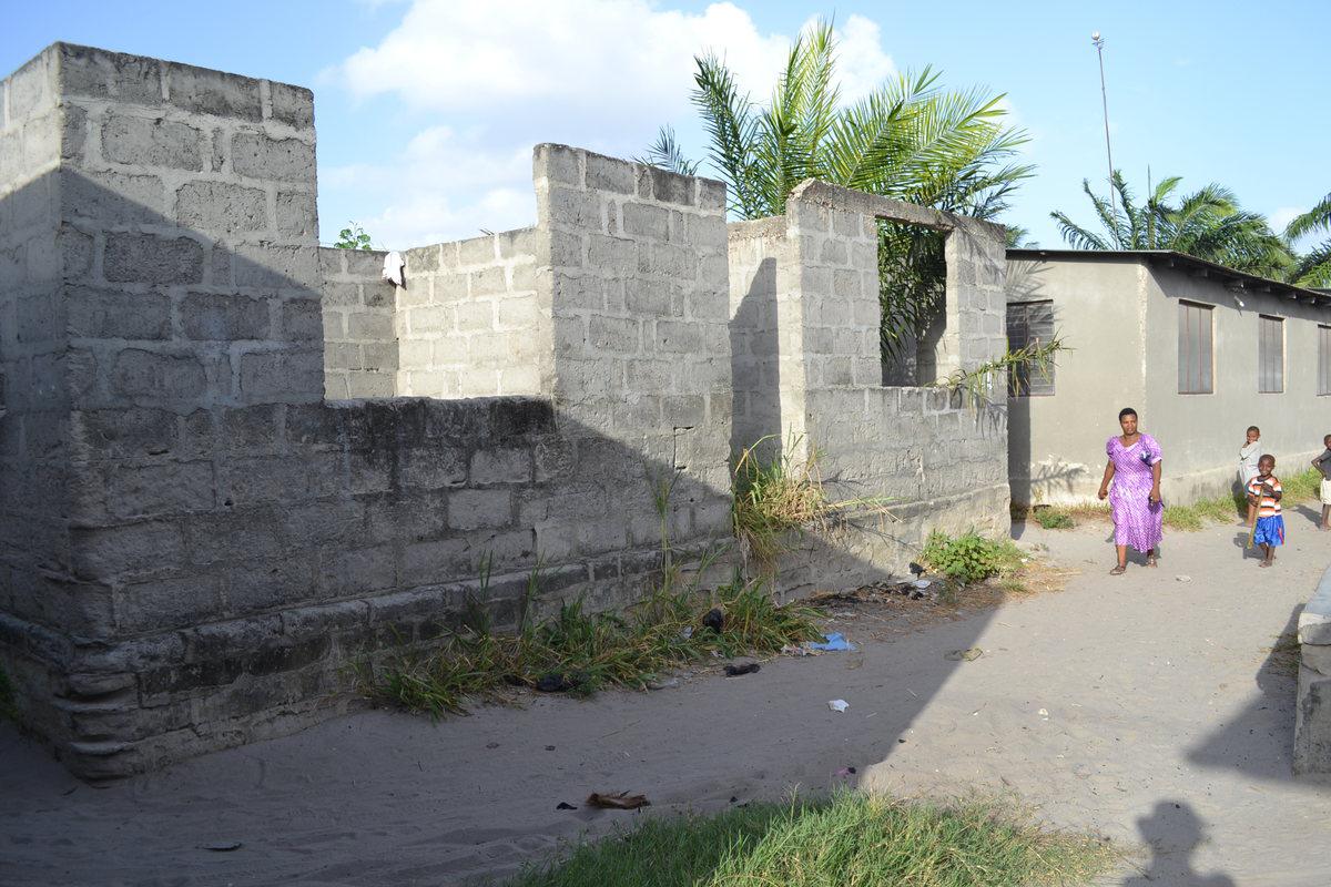 Some women who earn enough money are able to build houses back home for themselves and their families. Many women migrate with dreams of being able to build a house for their families. House construction, Majohe, Dar es Salaam, Tanzania.