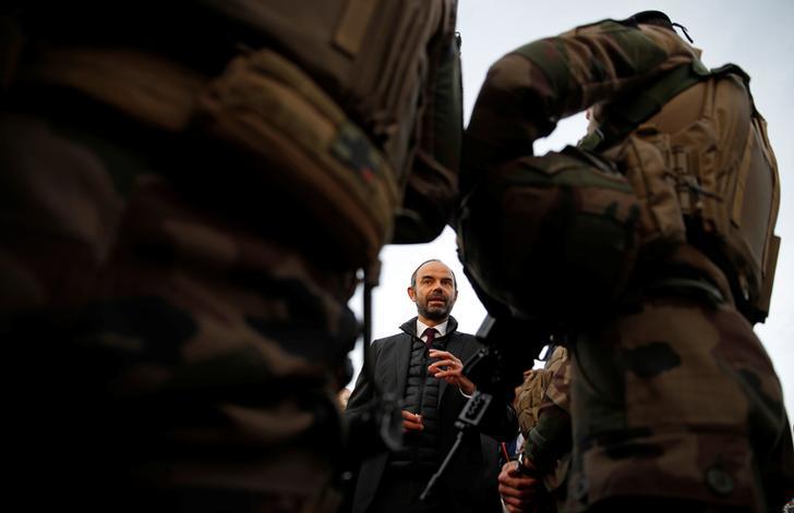 French Prime Minister Edouard Philippe meets soldiers during a visit at the Eiffel Tower in Paris, as France officially ended a state of emergency regime, replacing it with the introduction of a new security law, France, November 1, 2017. REUTERS/Christia