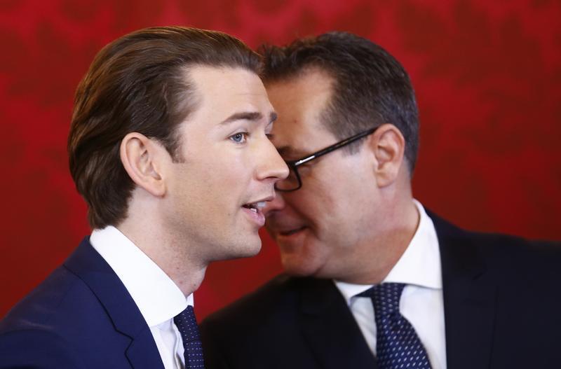 Head of the Freedom Party Heinz-Christian Strache (R) and head of the People's Party Sebastian Kurz react during the swearing-in ceremony of the new government in Vienna, December 18, 2017