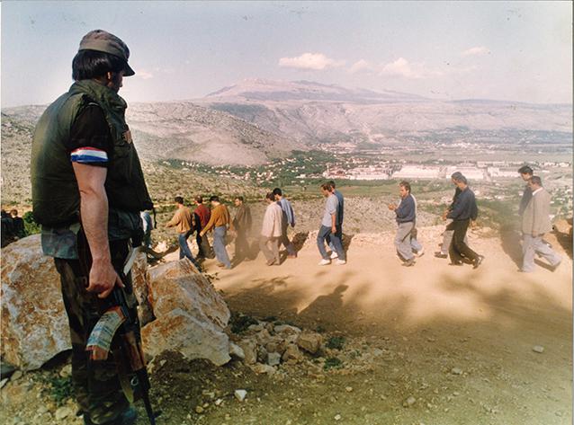 Some 300 Muslim residents of Mostar taken prisoner by Bosnian Croat forces are led down a dirt road towards an abandoned factory. This new wave of ethnic cleansing being arried by Croats was accompanied by heavy fighting in Mostar, May 11, 1993.
