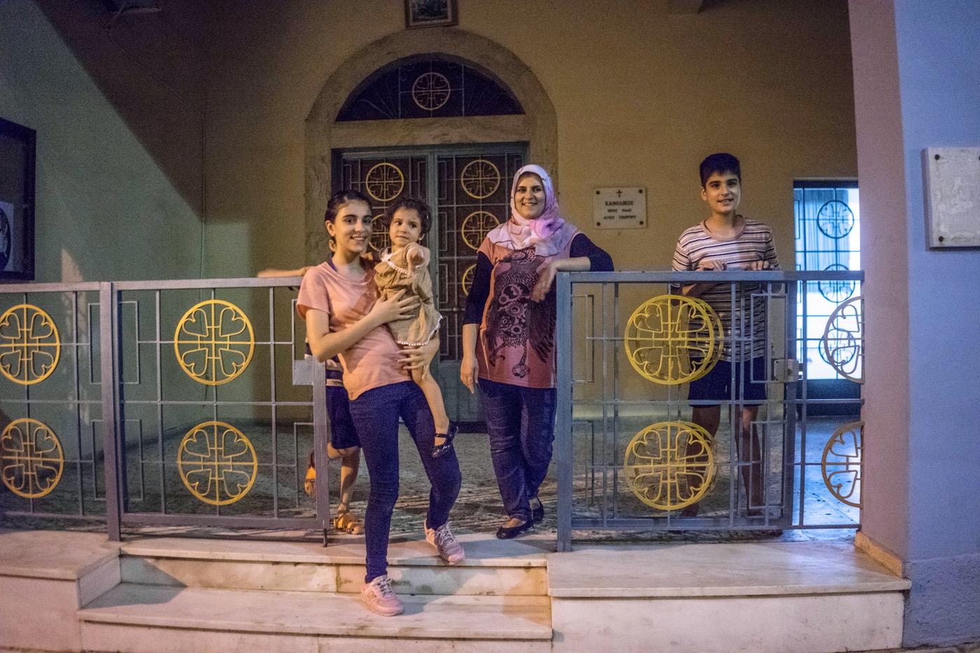 Falak’s family say goodbye to the Osanas as they leave the church accommodation in Aigaleo, Greece. © 2017 Anna Pantelia