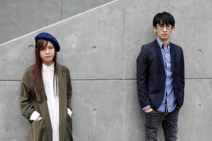 Disqualified lawmakers Yau Wai-Qing, 25, (L) and Baggio Leung, 30, pose outside government headquarters in Hong Kong, China on March 28, 2017. The two were arrested on April 26, 2017. 