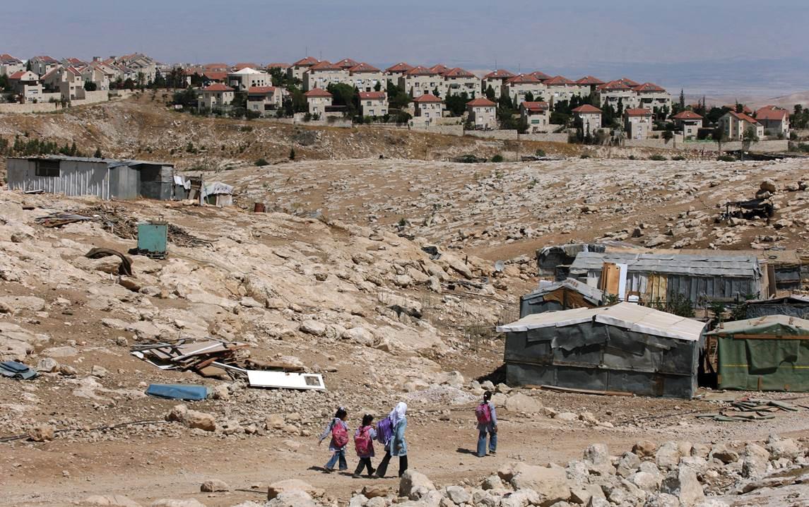 Palestinian Bedouin school children walk towards their tents on September 15, 2010 at their Bedouin camp outside the Israeli West Bank settlement of Ma'ale Adumin. Israel does not recognize the Bedouins’ property claims and has demolished homes and school