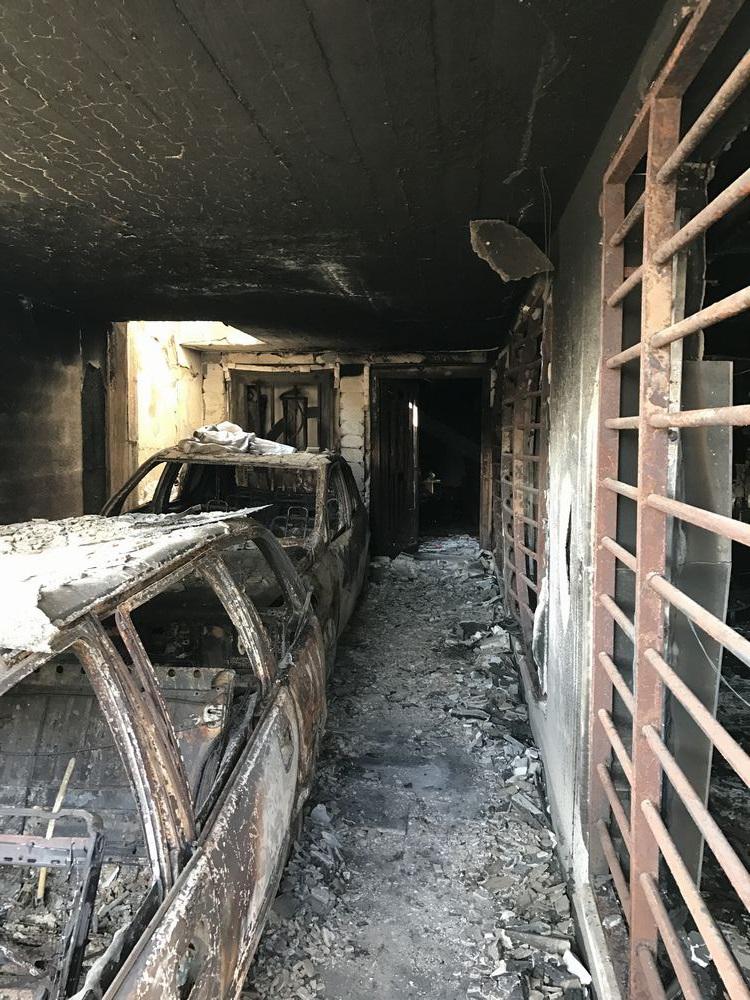 The remains of an apartment building in Falah neighbourhood that lit up in flames after an attack against ISIS forces on the street outside, on December 11, 2016. 16 civilians hid in the back of the building and eight were able to escape while the other e
