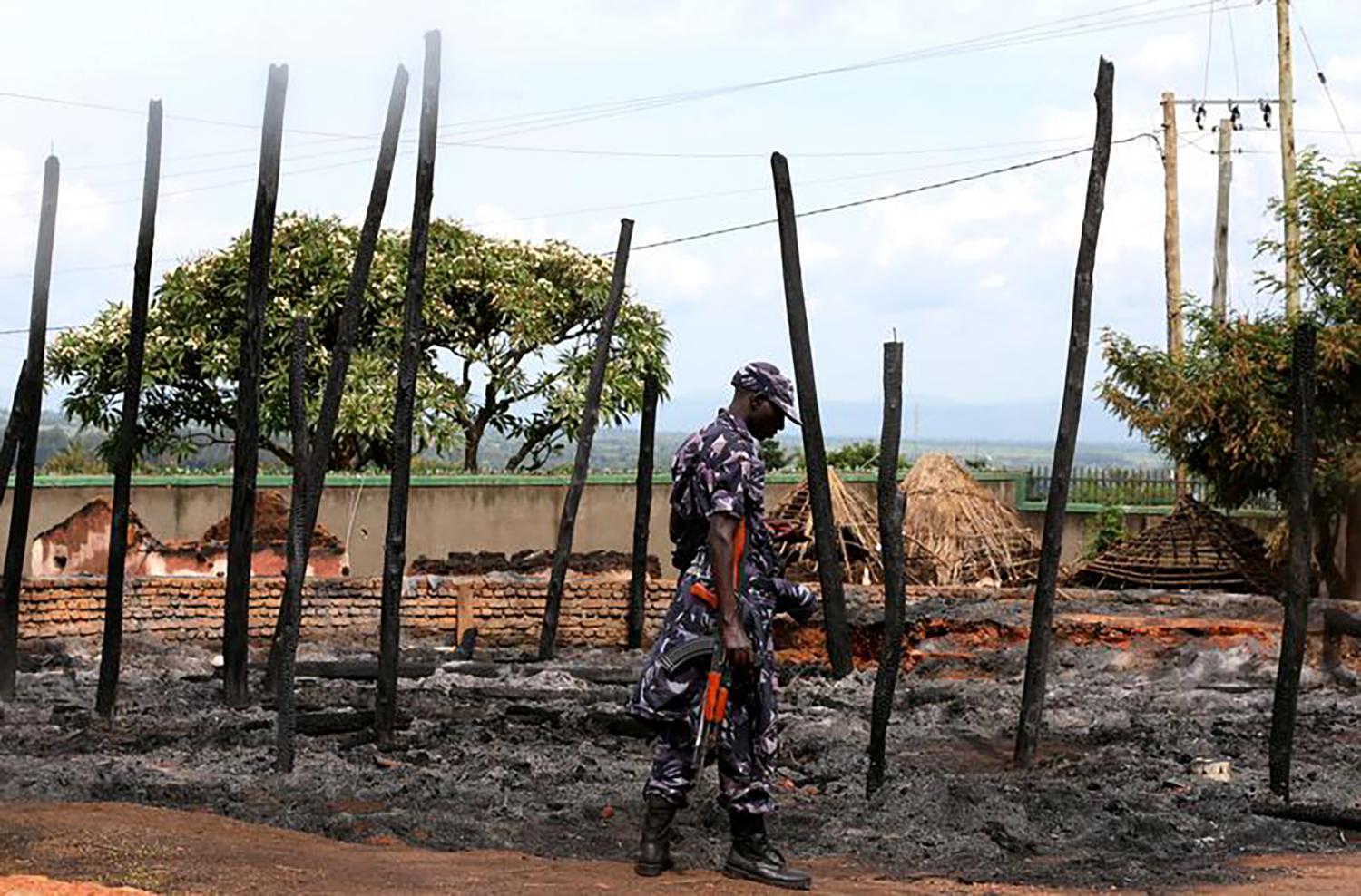 A Ugandan soldier guards the remains of the destroyed palace of Charles Wesley Mumbere, king of the Rwenzururu, after Uganda security forces stormed the compound in Kasese town, western Uganda on November 27. December 1, 2016.