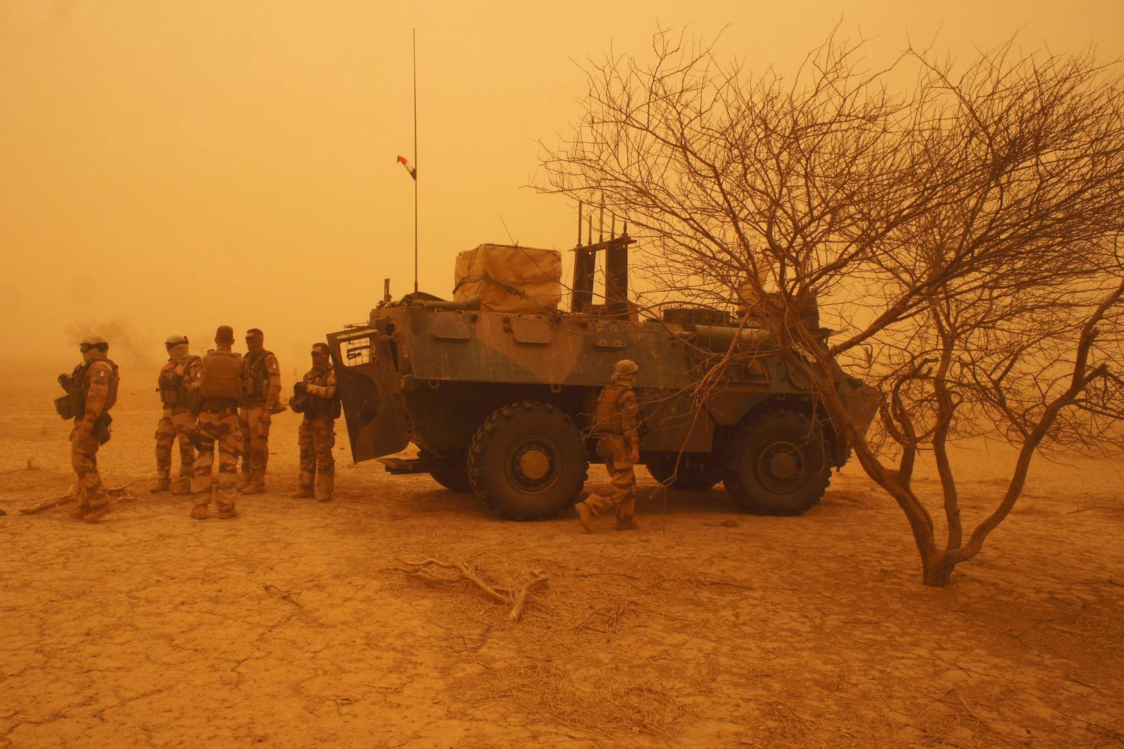 French soldiers from Operation Barkhane stand outside their armored personnel carrier during a sandstorm in Inat, Mali, May 26, 2016.