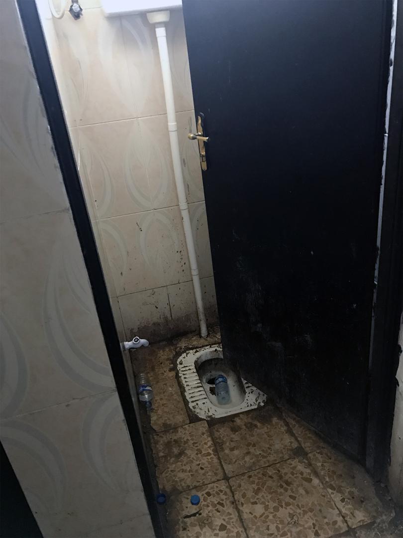 Dirty water blocks both sinks in the bathroom of Hammam al-Alil prison.
