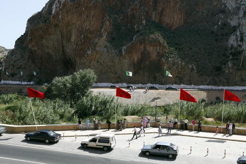 People stand near a border post on the Algerian side of the Morocco-Algeria border in the north east of Morocco July 31, 2011. © 2011 Youssef Boudlal /Reuters