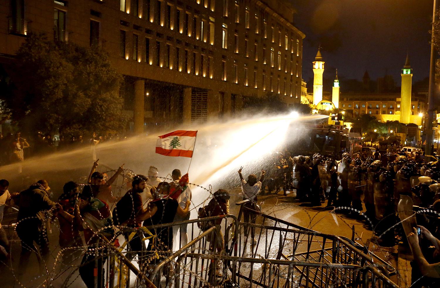 Security forces spray protesters demonstrating against a waste crisis and government corruption with a water cannon on October 8, 2015, after which 14 of the protesters were charged by the military prosecutor in Beirut.