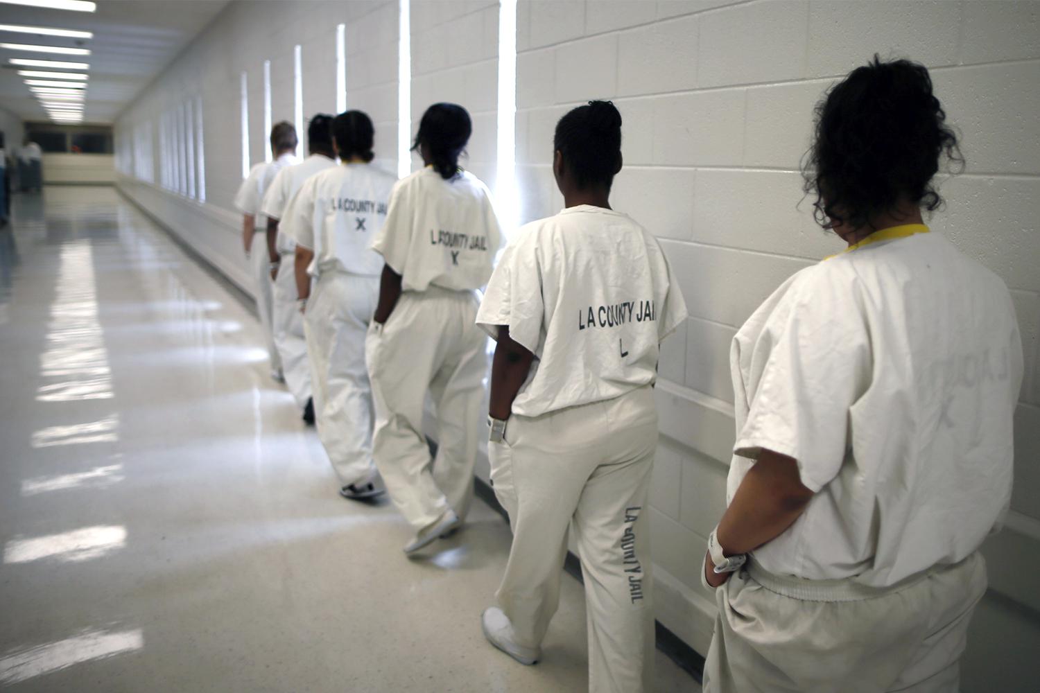 Women walk along a corridor at the Los Angeles County women's jail.