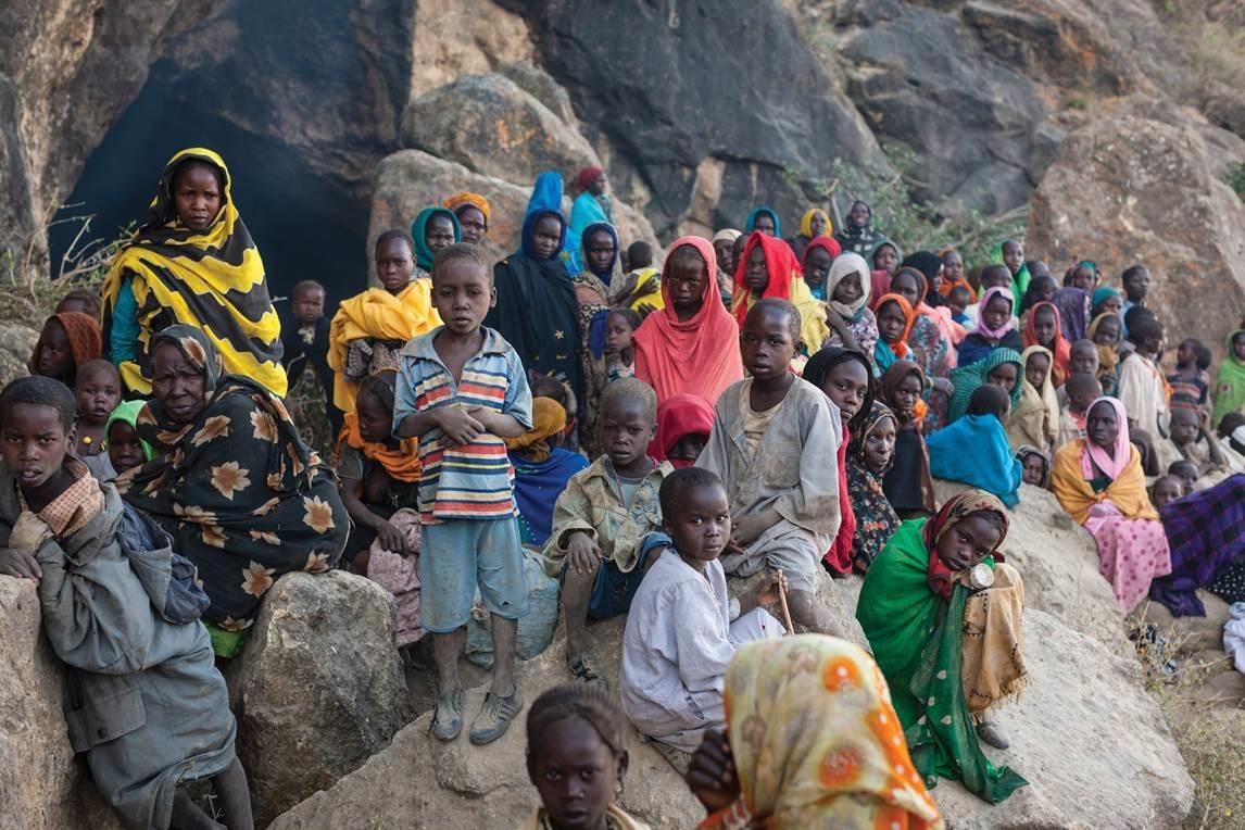 Women and children displaced by attacks of the Sudanese government Rapid Support Forces outside caves in rebel-controlled territory in Jebel Marra, Darfur, March 2, 2014. 