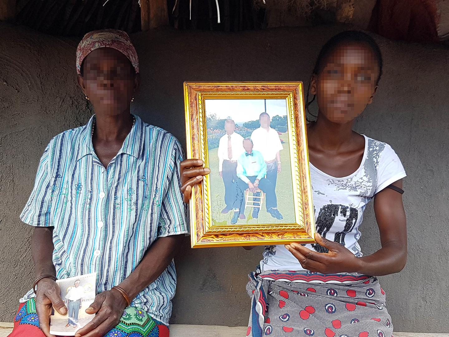 The wife and daughter of the regulo (traditional chief) of Muxungue, Makotori José Mafussi, show a photo of Mafussi (seated) and two relatives. Apparent Renamo fighters killed Mafussi at his home on July 21, 2016. 