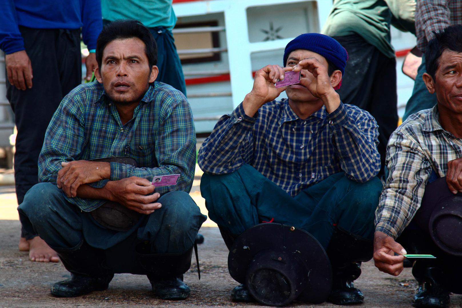 Burmese fishers present their pink cards during a Port-in, Port-out (PIPO) inspection in Laem Sing, Chantaburi, November 11, 2016. 