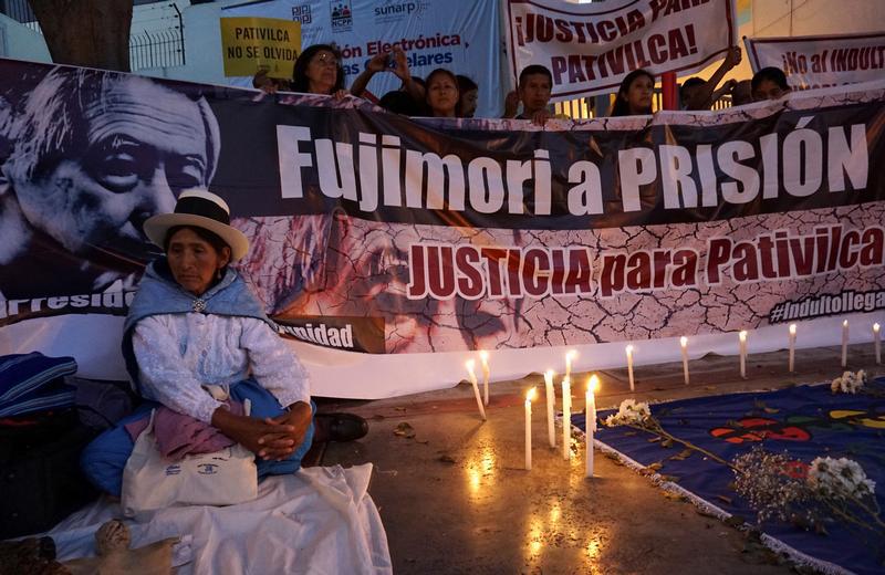 Relatives of victims of the guerrilla conflict in the 1980s and 1990s protest outside a court before a hearing on former Peruvian President Alberto Fujimori's pending trials, Lima, Peru, January 25, 2018. The banner reads: "Fujimori to prison, justice for