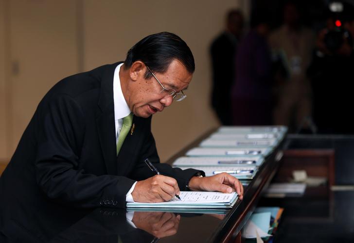 Prime Minister Hun Sen signs a register before a plenary session at the National Assembly of Cambodia, in Phnom Penh, February 14, 2018.