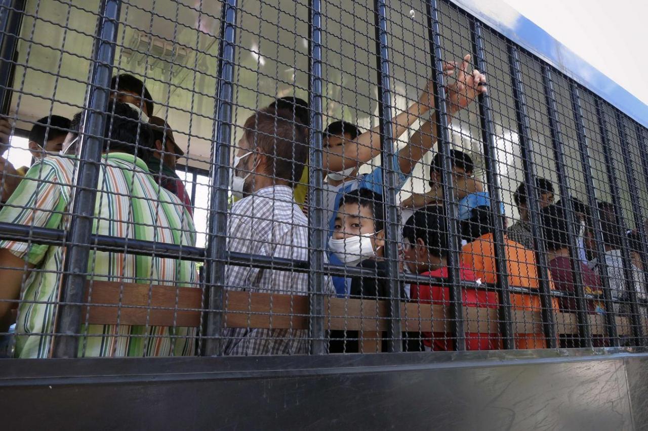 Ethnically Turkic people are transported back to a detention facility in the town of Songkhla in southern Thailand, March 26, 2014.