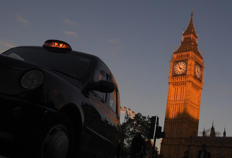 A London black cab taxi drives past Big Ben and the Houses of Parliament in late afternoon sunlight in London, Britain, November 10, 2016. 
